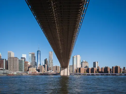 Photo 3: Interior · The Lower Manhattan skyline seen from beneath the deck of the Brooklyn Bridge, New York City, USA