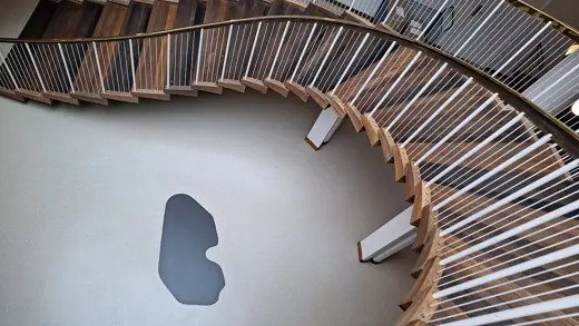 Photo 3: Interior · Spiral wooden staircase with brass handrail bannisters in Aarhus City Hall, Rådhuset, Denmark