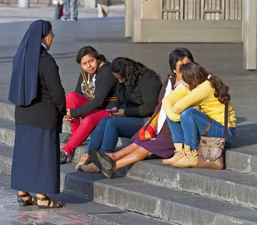 Photo 2: Exterior · A nun talking with some women on the steps of the new Basilica of Our Lady of Guadulupe in Mexico City