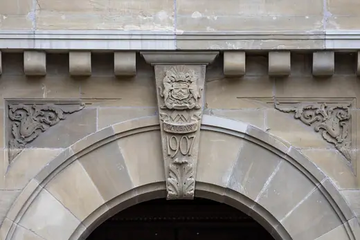Photo 2: Interior · Calgary City Hall, Calgary, Alberta, 2025-07-14; keystone with coat of arms and year