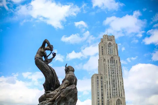 Photo 6: Detail · A 1918 landmark public sculpture in bronze and granite stand in front of the Cathedral of learning