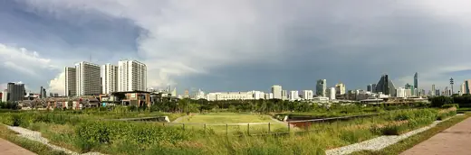 Photo 5: Context · The green roof of Chulalongkorn University Centenary Park and Bangkok skyline