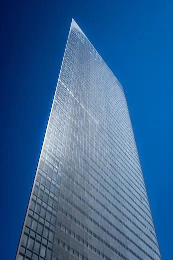 Photo 3: Exterior · Dentsu office, Tokyo, against a bright blue sky