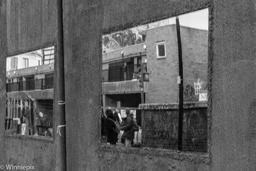 Photo 3: Detail · Passersby reflected in one of the "window's in David Adjaye's Dirty House in Shoreditch, London EC2