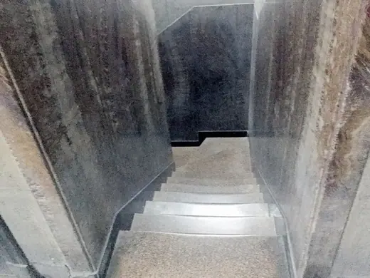 Photo 6: Interior · López Serrano Building_stairs to basement behind elevator