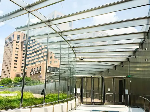 Photo 4: Interior · A glass revolving door with another door that enter inter into the Visitor Center