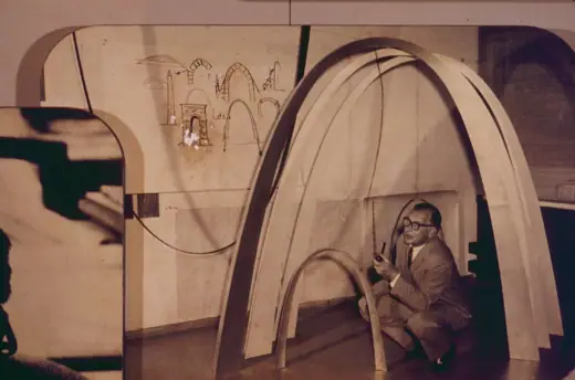 Photo 7: Model · Eero Saarinen with a model of the Gateway Arch