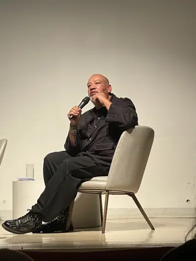 Photo 6: Interior · Picture of American artist Jeffrey Gibson on stage at the Hirshhorn Museum during an artist's talk