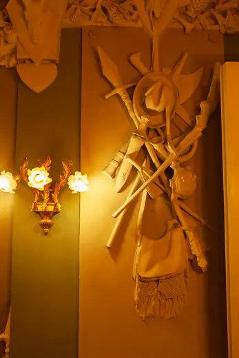 Photo 6: Interior · A detailed concrete sculpture of a hunting trophy on the wall inside the famous House with Chimaeras