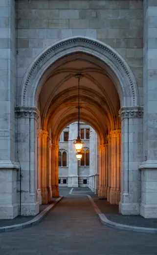 Photo 2: Exterior · Arch of the Hungarian Parliament Building (Országház), at twilight
