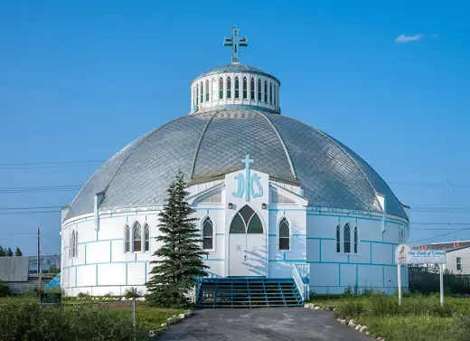 Photo 2: Exterior · Straight-on front view of Our Lady of Victory Church , Inuvik , NT, Canada, in 9:30 p.m