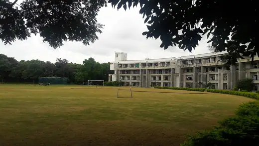 Photo 3: Exterior · A section of the hostel overlooking a field in IIMB