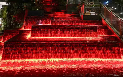 Photo 6: Interior · Cascade of water lit up red at night, Jewel Changi Airport, Singapore