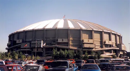 Photo 1: Exterior · The Kingdome, in Seattle, from across one of its parking lots in 1996