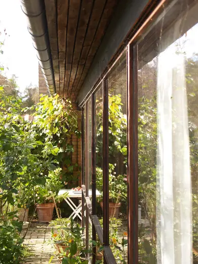 Photo 5: Interior · Kingo Houses by Jørn Utzon, livingroom glass wall seen from private courtyard