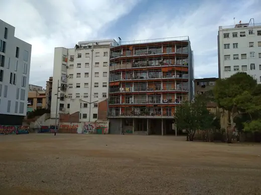 Photo 3: Exterior · La Borda housing cooperative building in Barcelona - rear facade, whole building in context