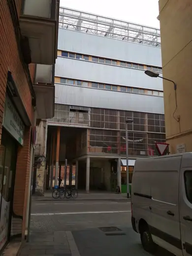 Photo 5: Context · La Borda housing cooperative building in Barcelona - front facede, photo from a narrow street