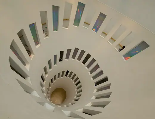 Photo 5: Interior · Aerial view looking down a spiral staircase with iridescent glass panel windows in Leeum museum in Seoul