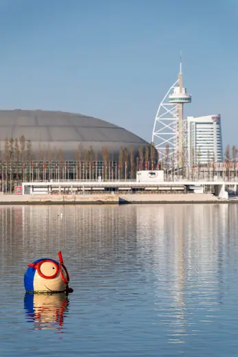 Photo 3: Exterior · Oceanarium's Vasco mascot with the Altice Arena and Vasco da Gama Tower in the background, Lisboa, Portugal
