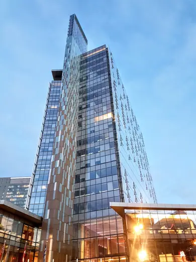 Photo 5: Context · Photo of Manitoba Hydro Place as seen from the sidewalk of Portage Avenue in the evening of May 18 2022
