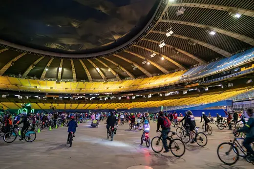 Photo 6: Interior · Cyclists ride inside the stadium during the 2019 Tour la Nuit
