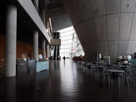 Photo 5: Interior · The foyer of the National Art Center, Tokyo with an information desk on the left and a cafe on the right