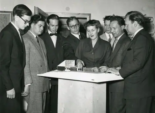 Photo 7: Model · Photograph of the Finnish architect Kaija Siren presenting a model of Otaniemi Chapel