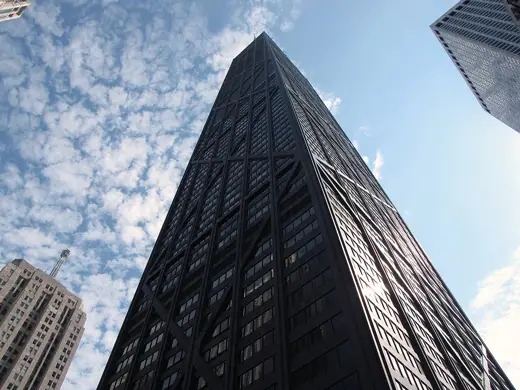 Photo 4: Exterior · Upward view of Michigan Avenue facade of the John Hancock Center, with surrounding buildings visible