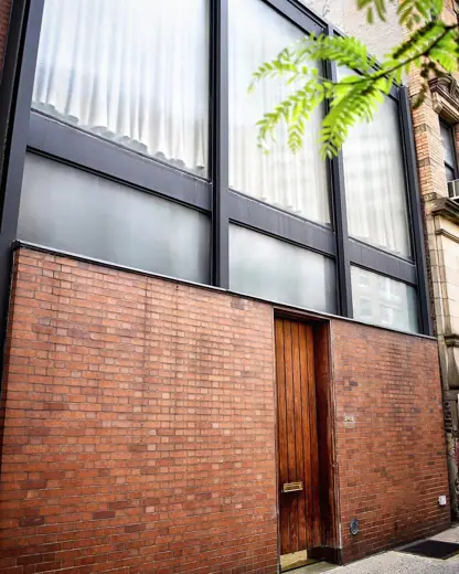 Photo 3: Exterior · Buried on a quiet block in the East 50s is this modernist gem