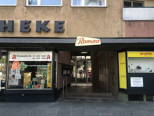 Photo 5: Interior · The entrance to the high-rise building Romeo with pharmacy and lottery office