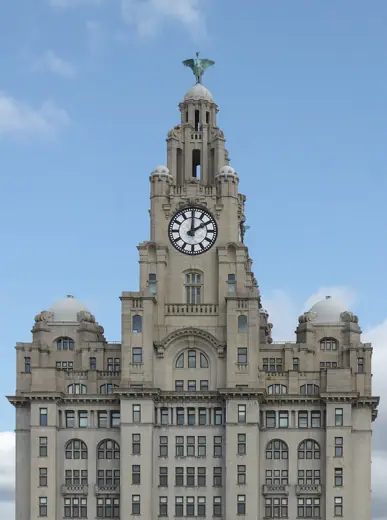 Photo 4: Exterior · Upper floors and clock tower of the Royal Liver Building, with domes and Liver bird