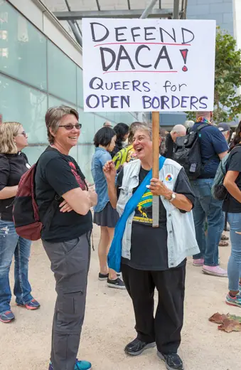 Photo 3: Exterior · A protester holds a sign at a DACA rally in San Francisco