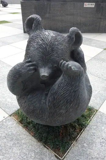 Photo 6: Detail · Bear sculpture outside building, around the cow sculpture