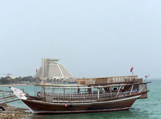 Photo 2: Exterior · Old boat with the Sheraton hotel in the background in Doha, Qatar