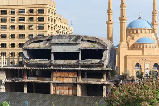 Photo 4: Exterior · The broken down southern face of the Egg, with Al Amine Mosque appearing behind