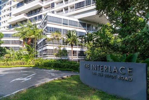 Photo 3: Exterior · The entrance sign of The Interlace, with the apartment blocks in the background