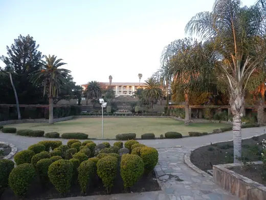 Photo 5: Context · Tintenpalast , seat of the namibiam parliament, with Parliament Gardens in the foreground
