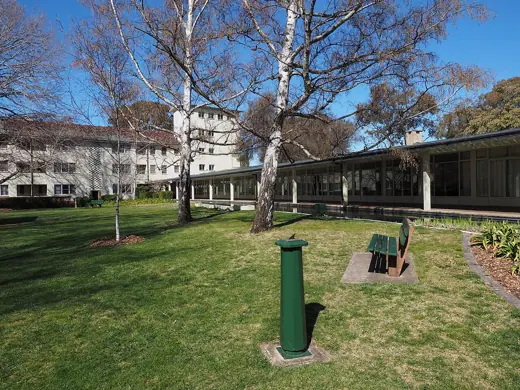 Photo 6: Context · Part of the lawn and gardens at University House in Canberra