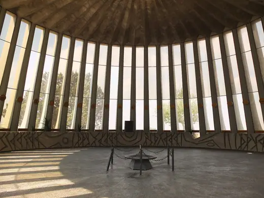 Photo 6: Interior · Yad Kennedy, Jerusalem Forest, interior with eternal flame and pillars decorated with state seals