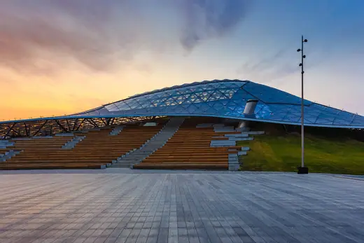 Photo 3: Exterior · The Grand Amphitheatre , covered with Glass Crust dome in Zaryadye park, Moscow, Russia at sunrise